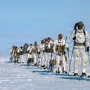 Green Berets assigned to the 10th Special Forces Group (Airborne) offload from an LC-130H “Skibird” operated by the 109th Airlift Wing of the New York National Guard on Aug. 18, 2026, at Camp Raven, Greenland, as part of Operation Apex Indigo. U.S. Special Operations Command North operates in Greenland alongside Danish counterparts to evaluate basic survival, search and rescue, cold-weather mobility, and communications infrastructure operations in the harshest environment on Earth, ensuring U.S. SOF capability to survive and thrive under any circumstances. U.S. Air National Guard Photo by Master Sgt. Jamie Spaulding (This photo was altered for security purposes)
