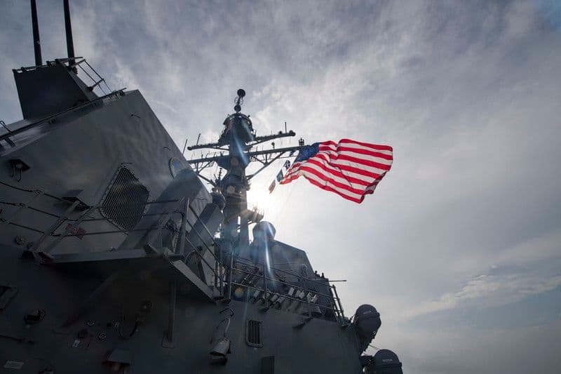 The Arleigh Burke-class guided-missile destroyer USS Michael Murphy (DDG 112) flies the ensign as it