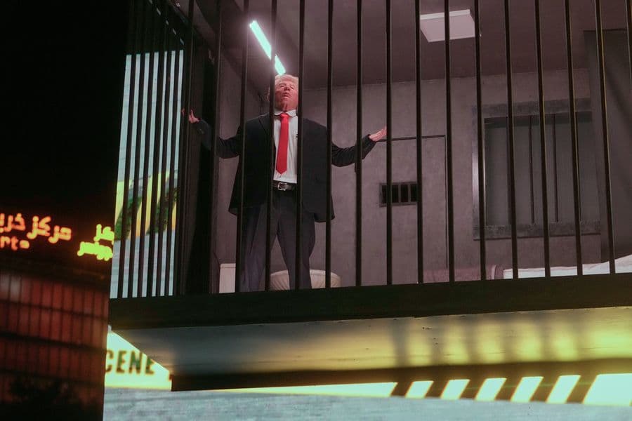 An actor portraying U.S. President Donald Trump sits behind bars in a billboard installation resembling a prison cell in Tajrish Square in Tehran, Iran, Wednesday, Oct. 21, 2026. (AP Photo/Vahid Salemi)