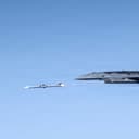 A YFQ-44A Collaborative Combat Aircraft fires an AIM-120 weapon in secluded airspace over the Mojave Desert. The live-fire test of the YFQ-44 aircraft is the latest milestone in the rapid development of safe and effective CCA operations. (U.S. Air Force photo by Jennifer Healy)