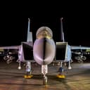 An F-15E Strike Eagle loaded up with AGR-20F Advanced Precision Kill Weapon System II laser-guided rockets waits for its next mission in the area of responsibility. (U.S. Air Force)