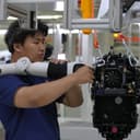 Workers assemble robot at the LY iTech Beijing Super Factory for Embodied Artificial Intelligence during a media tour in the Beijing E-Town on the outskirts of Beijing on May 29, 2026. (AP Photo/Andy Wong)