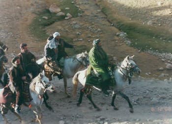General Dostum in the green riding chapan leading his horsemen to attack the Taliban in the spring of 2001 before the Americans came to assist him in his lonely struggle. (Picture given to Williams by Dostum).