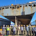 Adm. Steve Koehler, commander, U.S. Pacific Fleet, his staff, and shipyard employees tour the Lewis and Clark-class dry cargo ship USNS Wally Schirra (T-AKE 8) while in dry dock in Geoje-si, Republic of Korea, Oct. 24, 2024. The visit to the Republic of Korea underscored the United States’ commitment to an Indo-Pacific that is free and open, connected, prosperous, secure, and resilient. (Photo Courtesy of U.S. Navy)