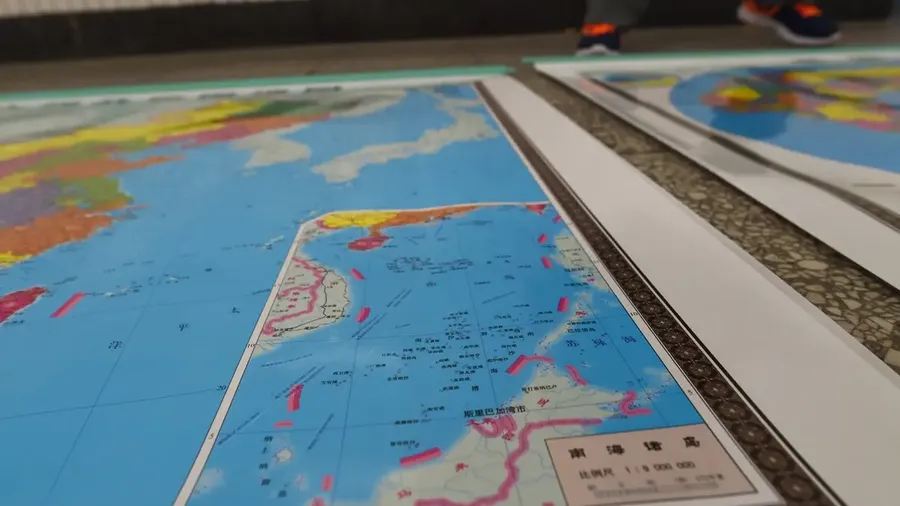 A map of China being sold in Beijing including an insert with red dotted lines showing China's claimed territory in the South China Sea (Greg Baker/AFP)