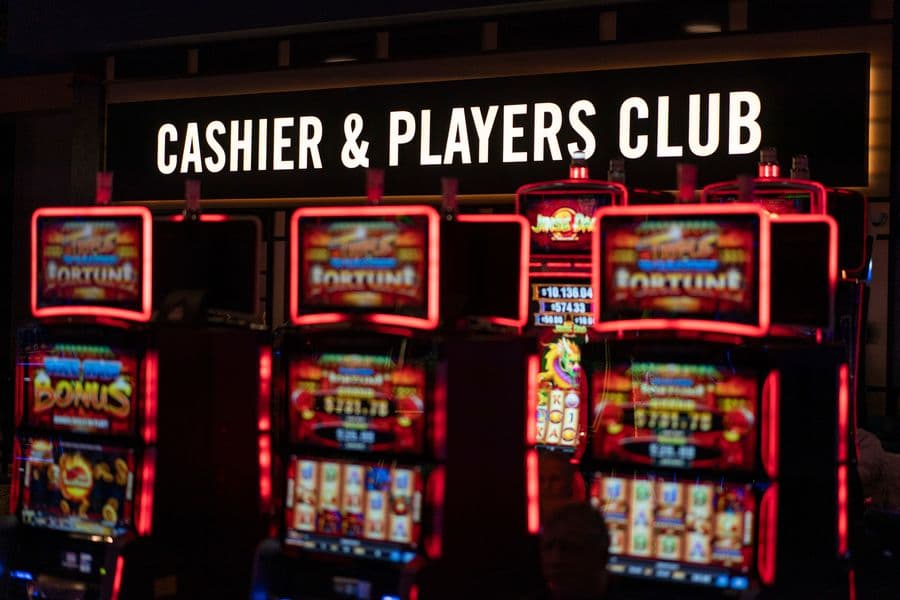 A sign directing bettors to a cashier is seen above electronic gaming machines at Turfway Park Racing & Gaming, Friday, Dec. 22, 2023, in Florence, Ky. Sports betting has spread rapidly across U.S. states in the past five years. But the odds for further expansion may be fading as state legislatures prepare to return to work in 2024. (AP Photo/Carolyn Kaster)