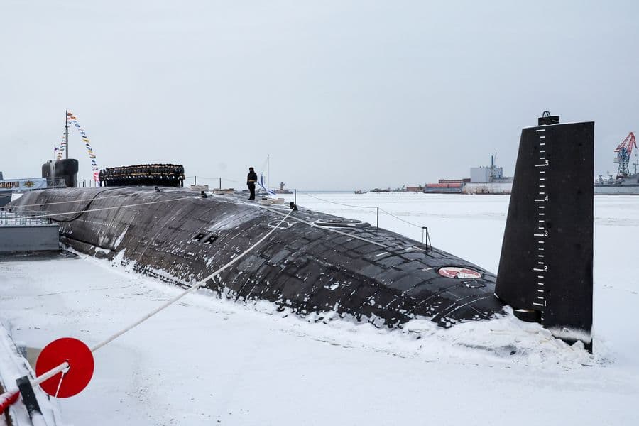 Russian sailors stand on deck of the newly-built nuclear submarine The Emperor Alexander III while Russian President Vladimir Putin attends a flag-raising ceremony on Monday for newly-built nuclear submarines at the Sevmash shipyard in Severodvinsk in Russia's Archangelsk region, Monday, Dec. 11, 2023. The navy flag was raised on the Emperor Alexander III and the Krasnoyarsk submarines during Monday's ceremony. Putin has traveled to a northern shipyard to attend the commissioning of new nuclear submarines, a visit that showcases the country's nuclear might amid the fighting in Ukraine. (Mikhail Klimentyev, Sputnik, Kremlin Pool Photo via AP)