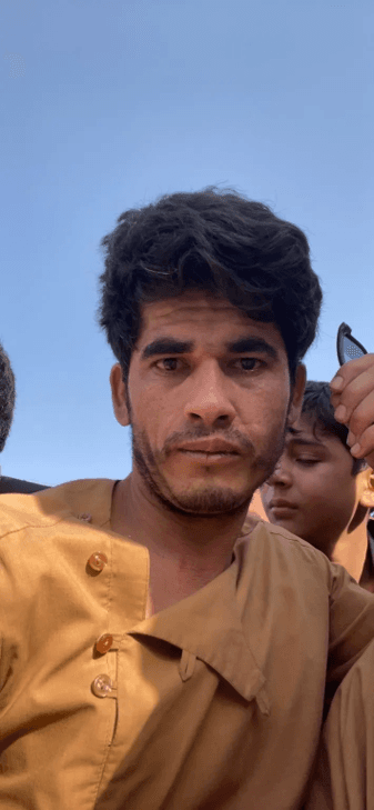 A selfie Nezam took of himself at the Karzai International Airport as he tried to get through the crowds and flash the Marines guarding a small hole in the fence a pineapple screen shot showing he was cleared for evacuation.